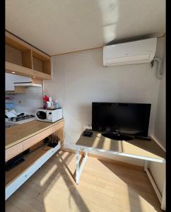 a small kitchen with a table and a microwave at Hongdae Sinchon Skyview in Seoul