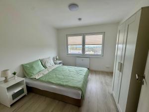 Postel nebo postele na pokoji v ubytování Apartmány Wolkenstein