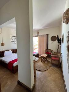 a bedroom with a bed and a table in a room at Amani Beach Villa- Bwejuu in Bwejuu +33 photos