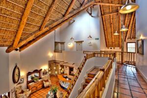 a large room with wooden ceilings and wooden beams at Oakhurst Hotel in George