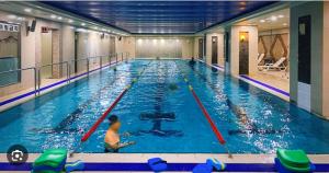 a man in a large swimming pool with paddles at Hongdae Sinchon Skyview in Seoul