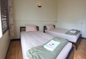 Postel nebo postele na pokoji v ubytování P.L.P Guesthouse - Mae Hong Son