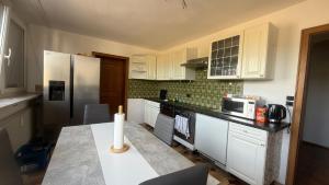 a kitchen with white cabinets and a candle on a counter at Wohnung Münchnerstrasse 54 Simbach am Inn Mü54 1 gross in Simbach am Inn
