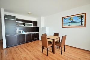a kitchen and dining room with a table and chairs at Millennium Apart Complex in Sveti Vlas