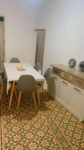a dining room with a table and chairs and a counter at Chic furnished apartment, Center in Tangier