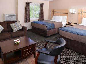 a hotel room with a couch and a bed at Econo Lodge Rochester I-90 & I-390 in Rochester +82 photos