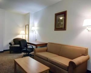 a living room with a couch and a table and chairs at Quality Inn & Suites Airport in Austin
