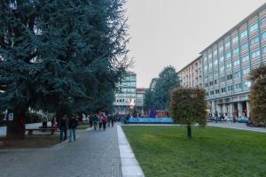 a group of people walking down a sidewalk in a city at La tana di Pumba in Cuneo