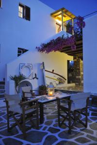 a table and chairs with a candle on a patio at Archipelagos Studios in Naousa