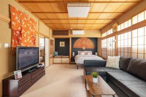 a living room with a couch and a bed at The Ivy Apartments, BEST Location, Yoyogi!! in Tokyo
