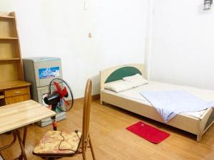 a small bedroom with a small bed and a chair at HouseTQV3 in Hanoi