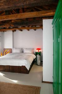 a bedroom with a bed and a red lamp at The Pelion Manifesto 2 in Agios Georgios Nilias
