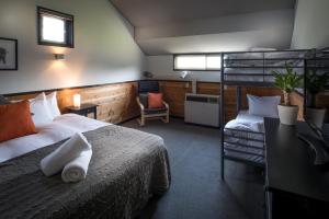 a bedroom with a bed and a bunk bed at The Phat House in Hakuba