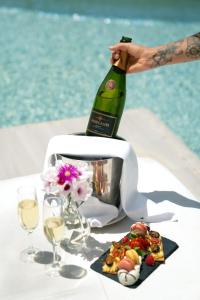 a bottle of wine is sitting on top of a toaster at Zahara Beach & Spa by QHotels - Adults Recommended in Zahara de los Atunes