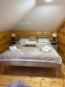 a bedroom with a large bed with two lamps at Vila Rudnicka Idila in Gornji Milanovac +16 photos