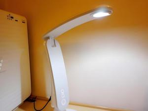 a white lamp sitting on top of a desk at Kushiro Royal Inn in Kushiro +112 photos