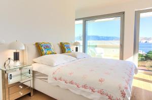 a bedroom with a bed with a view of the ocean at The Oscar in Baška +63 photos