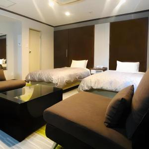 Giường trong phòng chung tại Urban Place Inn Kokura