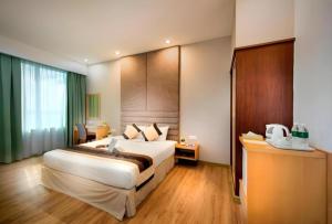 a bedroom with a large bed in a room at Kingwood Hotel Mukah in Mukah +126 photos