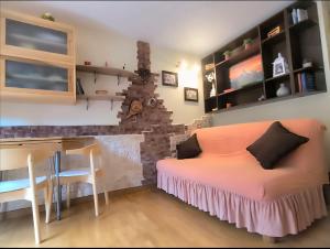 a bedroom with a bed and a desk and a table at Dima Home Campo di Giove in Campo di Giove