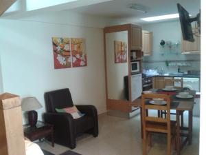 a kitchen with a table and a dining room at Casa Entre Serras in Donas