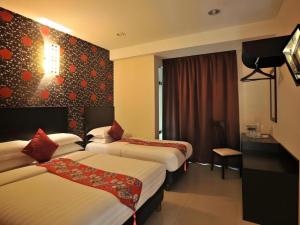 a hotel room with two beds and a television at Sea Lion Hotel @ Klang in Klang +61 photos