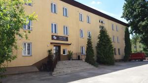 a yellow building with stairs in front of it at SCSK Pół Ławy in Puławy