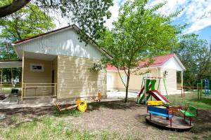 a yard with a playground and a house at Взлет in Gelendzhik