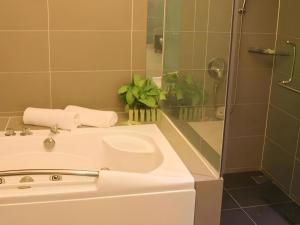 a bathroom with a white sink and a shower at Mornington Hotel Medan Ipoh in Kampong Simee +35 photos