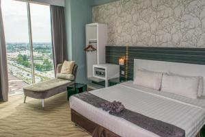 Ένα ή περισσότερα κρεβάτια σε δωμάτιο στο MH Hotels Ipoh +203 φωτογραφίες