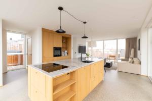 a kitchen with wooden cabinets and a counter top at Nørrebrogade 209 in Copenhagen