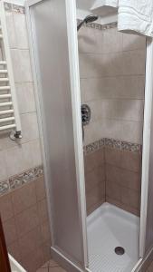 a shower with a glass door in a bathroom at Maison Largo delle Grotte in Ordona