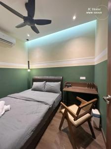 a bedroom with a bed and a desk and a ceiling fan at Jalan Rusa Happy hour 10pax KTV Walkable to KSL Mall Johor Bahru in Johor Bahru