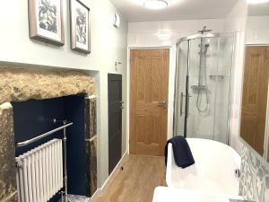 a bathroom with a shower and a white tub at Weavers Rest - New Boutique Retreat in Central Skipton with Parking in Skipton