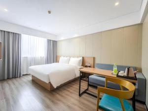 Postel nebo postele na pokoji v ubytování Borrman Hotel Xiamen Xiang'an Maxiang