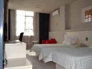 a hotel room with a bed and a red chair at JinJiang Inn Nanchang Bayi Square Ximazhuang Food Street in Nanchang +240 photos