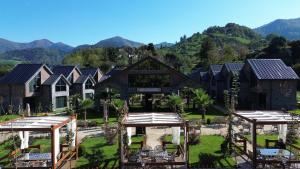 an aerial view of a house with mountains in the background at Newrose hotels in Kemalpasa