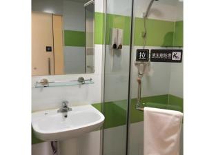 a bathroom with a sink and a shower at 7 Days Inn Urumqi Guangming Road Beimen Metro Station in Ürümqi +60 photos