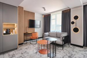 a living room with a couch and a table at voco Katowice by IHG in Katowice