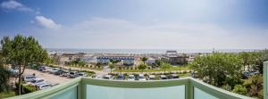 a balcony with a view of a parking lot at Costa del Sole Only Room in Milano Marittima