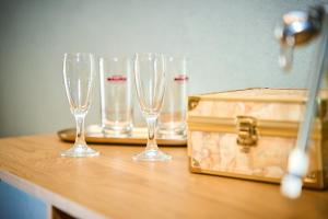 four wine glasses sitting on a table with a briefcase at Nishan 249 in Cosenza +26 photos