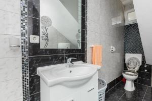 a bathroom with a sink and a toilet at Apartment Anna in Kaštela +20 photos
