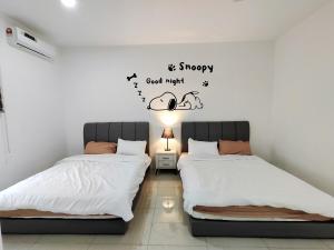 a bedroom with two beds and a good night words at 2Op Ipoh, Semi D, in Ipoh