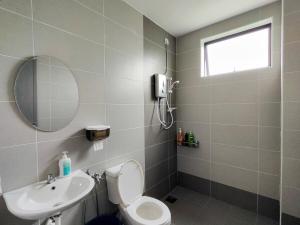 a bathroom with a toilet and a sink and a mirror at 2Op Ipoh, Semi D, in Ipoh +73 photos