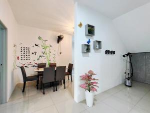 a dining room with a table and chairs at 2Op Ipoh, Semi D, in Ipoh