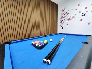 a blue pool table with cue balls and cues at 2Op Ipoh, Semi D, in Ipoh