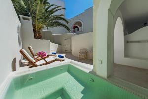 a swimming pool in the middle of a house at Atlantis Beach Villa in Perivolos