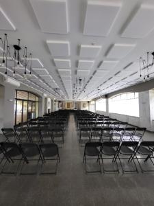 an empty hall with empty chairs in a building at Hostal by El Collell TODO INCLUIDO in Sant Ferriol +21 photos