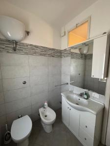 a bathroom with a white toilet and a sink at Casa Altobelli in Borgo San Pietro +13 photos