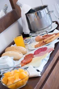 a table topped with breakfast foods on a counter at Hotel Toboso Chaparil in Nerja
